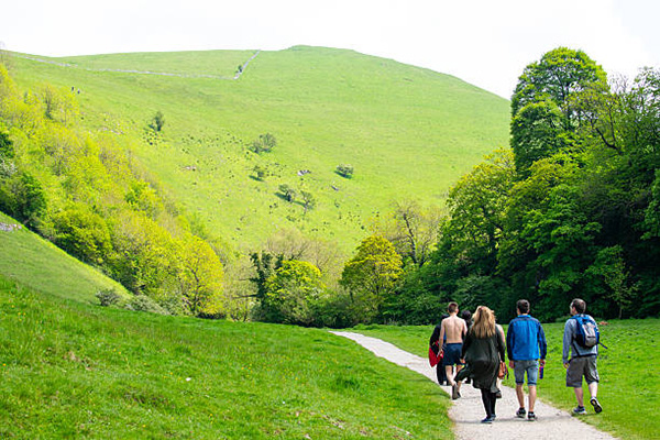 Derbyshire, UK - May 29, 2016: Visitors exploring the landscapes and forest in the Dovedale valley in the Peak District of England.