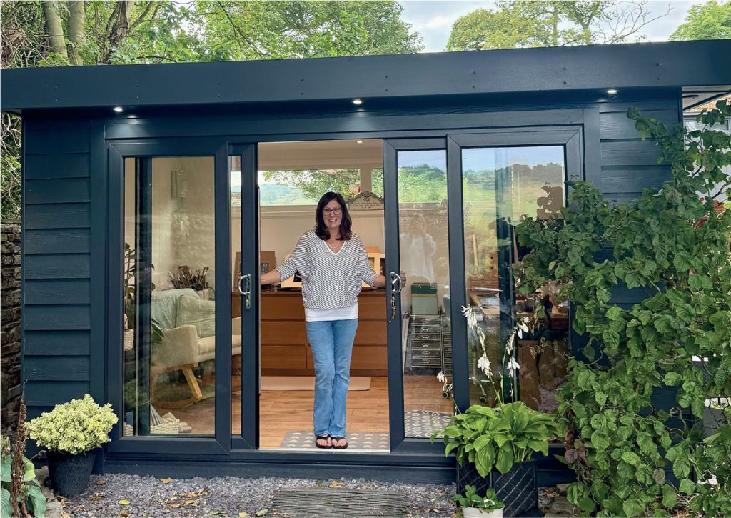 Diane Spencer, an artist living in the village of Higham, Derbyshiren in the doorway of her new garden room