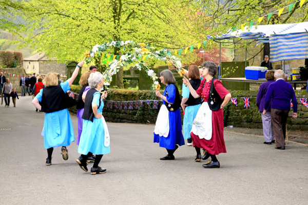 Ashover, Derbyshire, UK. May 04, 2015.  A group of female Garland dancers entertain at the village carnival at Ashover in Derbyshire.