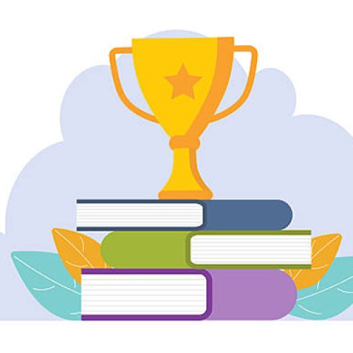 Golden trophy cup standing on the books. Business goal, idea. Victory concept