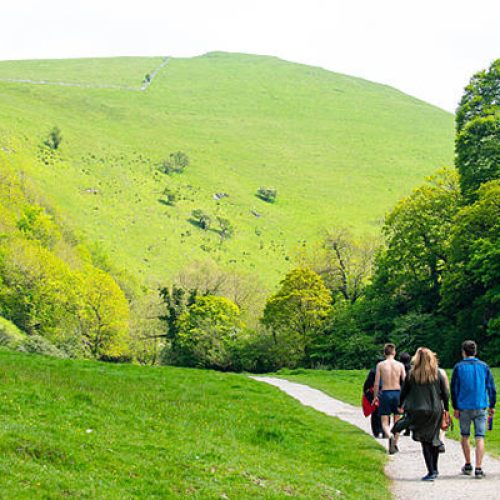 Derbyshire, UK - May 29, 2016: Visitors exploring the landscapes and forest in the Dovedale valley in the Peak District of England.